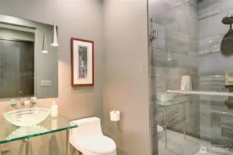 This delightful powder room for guests also has a 3/4 tiled shower.