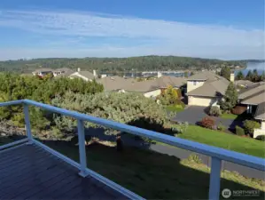 Relax outside and inside with abounding views of water.  Mountain views to the west also abound throughout this home.