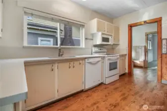 Luxury vinyl plank flooring flows throughout the kitchen & dining area.