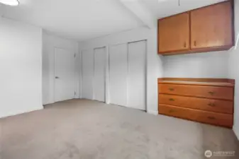 Dual closets plus a built-in dresser provide ample storage space.