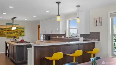 The large, chef's kitchen makes room for several cooks at once and includes both a breakfast bar and eat-in counter space.