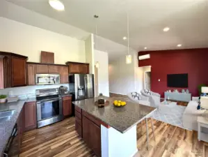 Photo is of virtually staged kitchen/living area