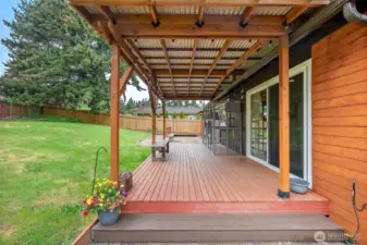 Expansive covered deck with sliding glass door access—ideal for indoor-outdoor living year-round.