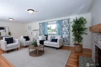 Don't miss the coved ceilings - large windows bring in great light, making this living room a perfect spot to relax and visit.