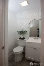 Updated and adorable half bath adjacent to primary bedroom.
