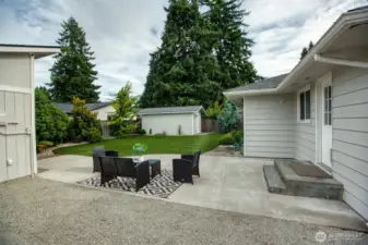 Large sunny patio overlooking your easy-care turf yard, designed with privacy trees across the back.