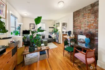 Apartment 5 – Ground-Floor Gem with Garden Outlook  Apartment 5 makes the most of its position with leafy views, warm morning light, and rich historic details—including a full exposed brick wall and original wood floors. Tidy yet expressive, this unit has attracted long-term residents who value both privacy and personality. A peaceful back-of-building unit with easy access to the shared laundry and private outdoor deck.