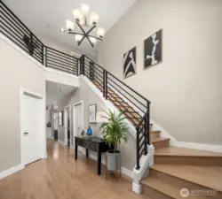 A welcoming 2-story entry with a contemporary steel handrail sets the tone for gathering & connection.