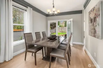 Multiple doors lead to the private fully fenced 8,349sf  CORNER LOT with mature landscaping and a custom paver patio—ideal for PLAY, pets, and outdoor ENTERTAINING.