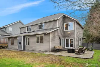 The private fully fenced 8,349sf  CORNER LOT with mature landscaping and a custom paver patio—ideal for PLAY, pets, and outdoor ENTERTAINING.