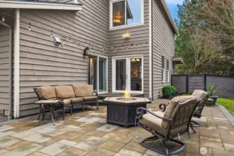 The private fully fenced 8,349sf  CORNER LOT with mature landscaping and a custom paver patio—ideal for PLAY, pets, and outdoor ENTERTAINING.