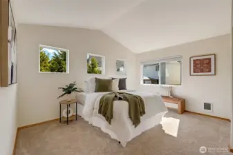 Large Primary Bedroom with vaulted ceilings and an abundance of windows for natural light