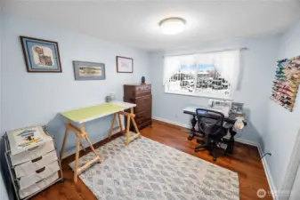 The third bedroom is currently used as a sewing room.  It, just like the other two bedrooms, features a large window and good closet space.