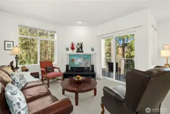 Spacious living room anchored by a cozy wood-burning fireplace