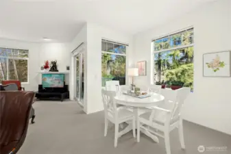 Large windows frame tranquil greenbelt views