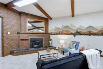 Generous family room with a wood stove, new carpet, and flexible space for relaxing, hobbies, or gatherings.