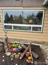 Colorful flower bed adds charm and a welcoming touch along the path to the front door.