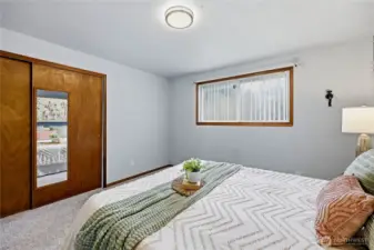 Another look at the primary bedroom highlighting its natural light and spacious feel.