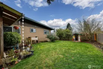 Enjoy outdoor living in this fully fenced backyard with open green space, garden areas, and room to play or unwind.