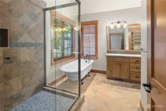 Tiled shower with pebble flooring.