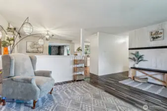 Front room w/view into kitchen w/window located over sink to view back deck overlooking property.