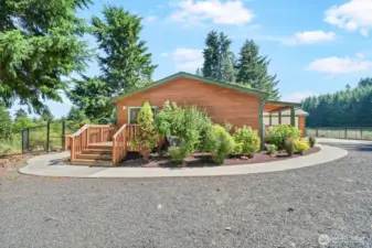 Beautifully crafted custom concrete sidewalks surround the home, enhancing both curb appeal and functionality.