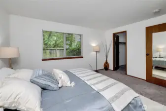 Quiet bedroom with window privacy and walk-in closet.