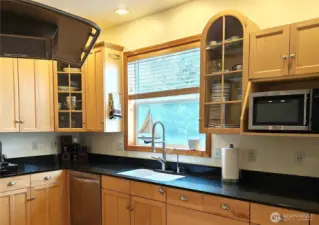 Glass fronted cabinets show off your lovely dishware etc. Window opens and overlooks the BBQ  area.