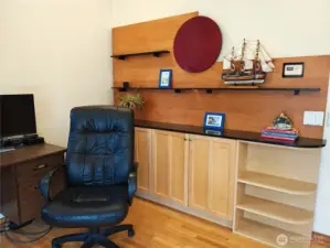 Custom built in maple cabinetry and shelving that conveys