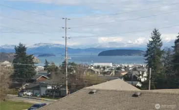 View from the primary bedroom of mountain ranges and Fidalgo bay.