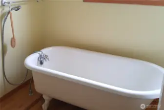 Primary bathroom. Unique claw foot tub originally from historic Rosario resort on Orcas island