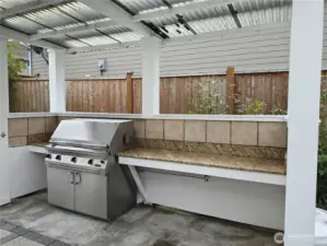 Pergola covered area was created to protect the BBQ chef. Granite counters either side of the built -in stainless steel BBQ. Estimated original cost of $7000. BBQ conveys.