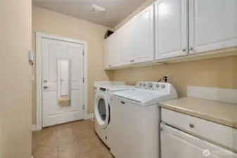 Laundry Utility room with extra storage and counter space. Leads to garage.