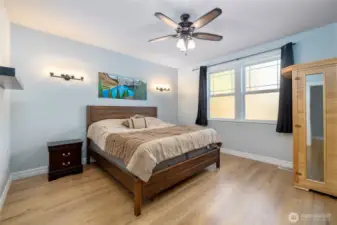 Primary bedroom on main floor with light filled large windows and lots of space.