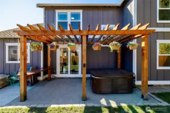 Pergola in backyard with room for gardening, play, or relax in the hot tub.
