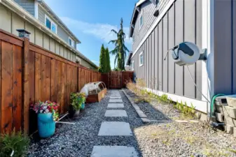 Well maintained side yard with garden space.