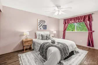 Primary Bedroom with Newer Hardwood Floors, His and Her Closet.