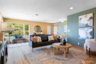 Light filled living room with newly refinished hardwood floors.