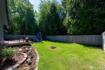 With vibrant landscaping and a manicured lawn, this backyard is ready for summer BBQs, morning coffee, or cozy nights by the fire.