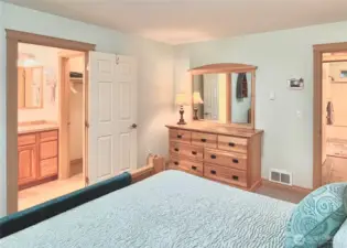 View from the Primary Bedroom,   Highlighting the Large En-Suite Bathroom,   Expansive Walk-In Closet, and the Door   Leading to the Hallway. The Layout Offers a   Tranquil and Quiet Retreat, Just Steps Away   from the Kitchen for Ultimate Convenience.