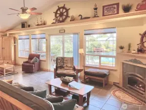 Breathtaking Interior with Expansive Water   Views and Captivating Shimmering   Reflections, Offering the Ultimate Waterfront   Lifestyle. This Luxurious Space Features   Premium Upgrades, Including Custom   Uplighting, Built-In Speakers, a Cozy   Fireplace, and Two Grand Sitting Areas —   Perfect for Relaxation or Entertaining. An   Exceptional Blend of Comfort, Elegance, and   Modern Technology.