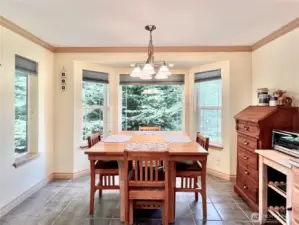 Charming Kitchen Table and Dining Area,   Conveniently Located Right Off the Kitchen.    This Space Invites You to Bring in Your BBQ   and Serve Guests with Ease, Creating the   Ideal Spot for Casual Dining and Gatherings