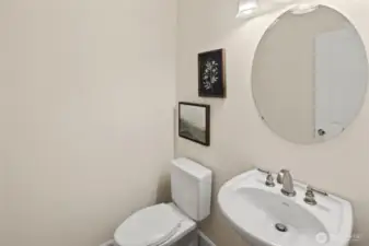 The convenient powder room off the kitchen is placed for easy access and ideal for guests.