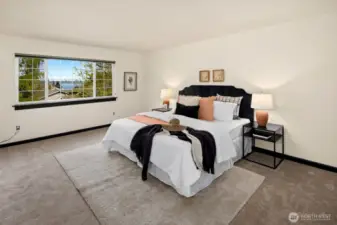 Take in a serene view of Puget Sound from bed—this airy primary suite offers restful vibes and room to breathe.