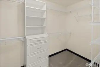The walk-in closet in the primary suite provides excellent built-in drawers, shelving, and generous hanging space.