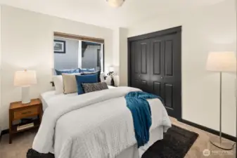 Fresh carpet, freshly painted trim, and ample closet space make this comfortable guest bedroom a welcoming retreat.