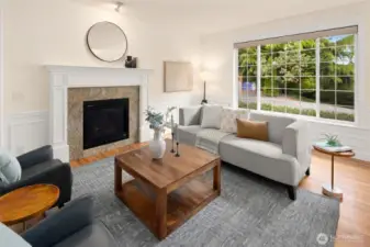 A wide, west-facing front window frames the leafy neighborhood beyond—bringing in abundant light and creating the perfect perch for a peaceful start to the day.