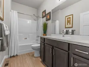 Just down the hall is a full bathroom, conveniently located for guest access.