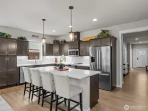 Gorgeous cabinets and stunning countertops elevate the space.