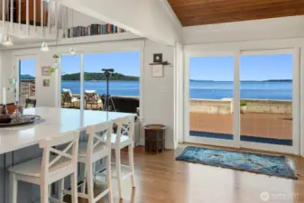 Fir tongue and groove vaulted ceiling, new floor to ceiling windows, and new oak flooring are just a few of the recent improvements. The open concept home flows beautifully from the inside to the outdoors. Blake Island in the distance.